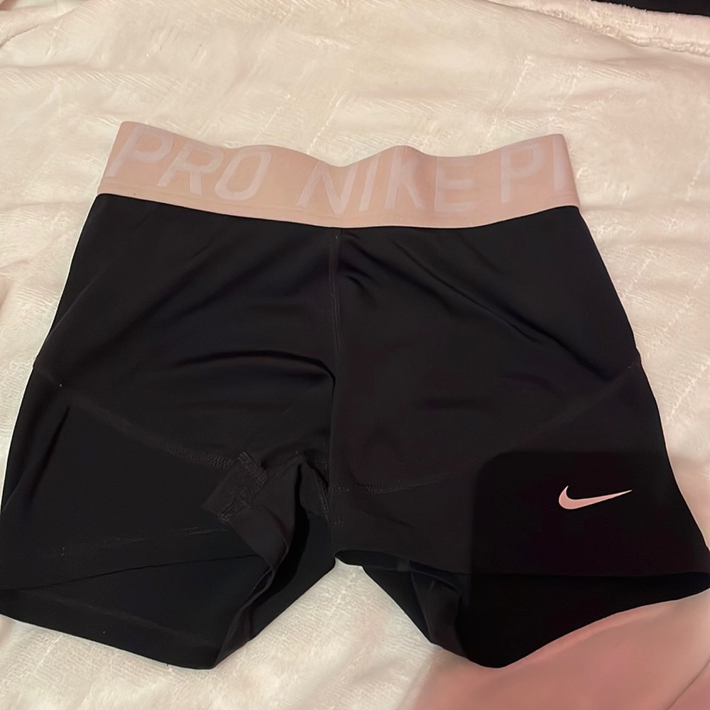 Black Nike pros with pink band